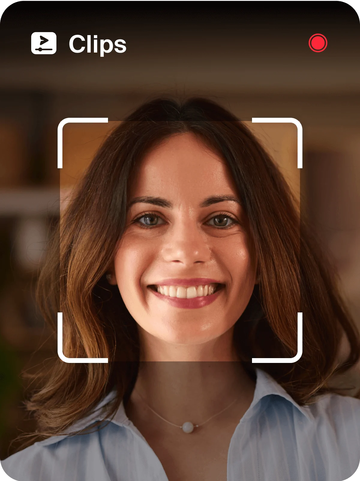A smiling woman poses in front of a camera in Zoom Clips, radiating joy and confidence.