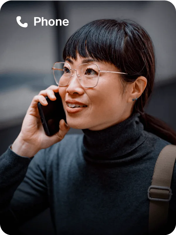 A woman engaged in a conversation on Zoom Phone, smiling as she talks.